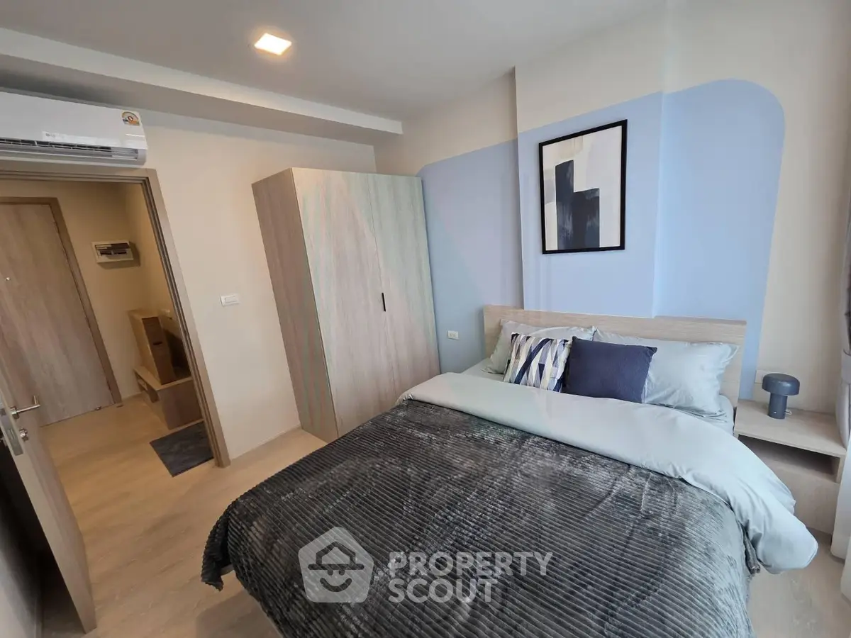Modern bedroom with stylish decor and cozy ambiance in a contemporary apartment.