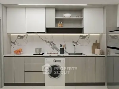 Modern kitchen with sleek cabinetry, marble backsplash, and built-in washing machine.