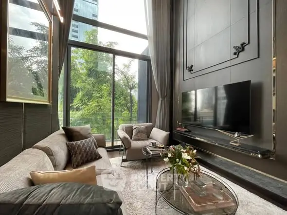 Luxurious living room with high ceilings, large windows, and modern decor in a stylish apartment.
