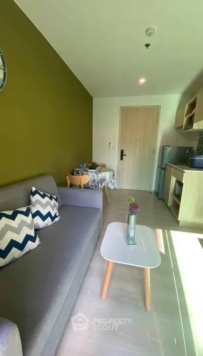Modern living room with stylish decor and open kitchen layout, perfect for cozy urban living.