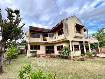 Charming two-story house with lush garden and spacious balcony, perfect for family living.