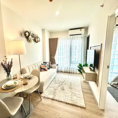 Modern living room with cozy decor and natural light in a stylish apartment.