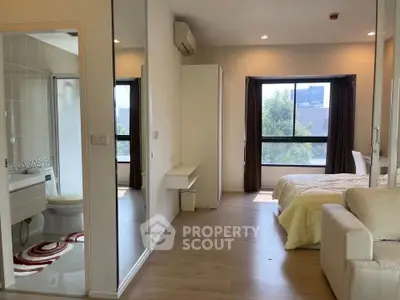 Modern studio apartment with open layout, featuring a cozy bedroom and stylish bathroom.