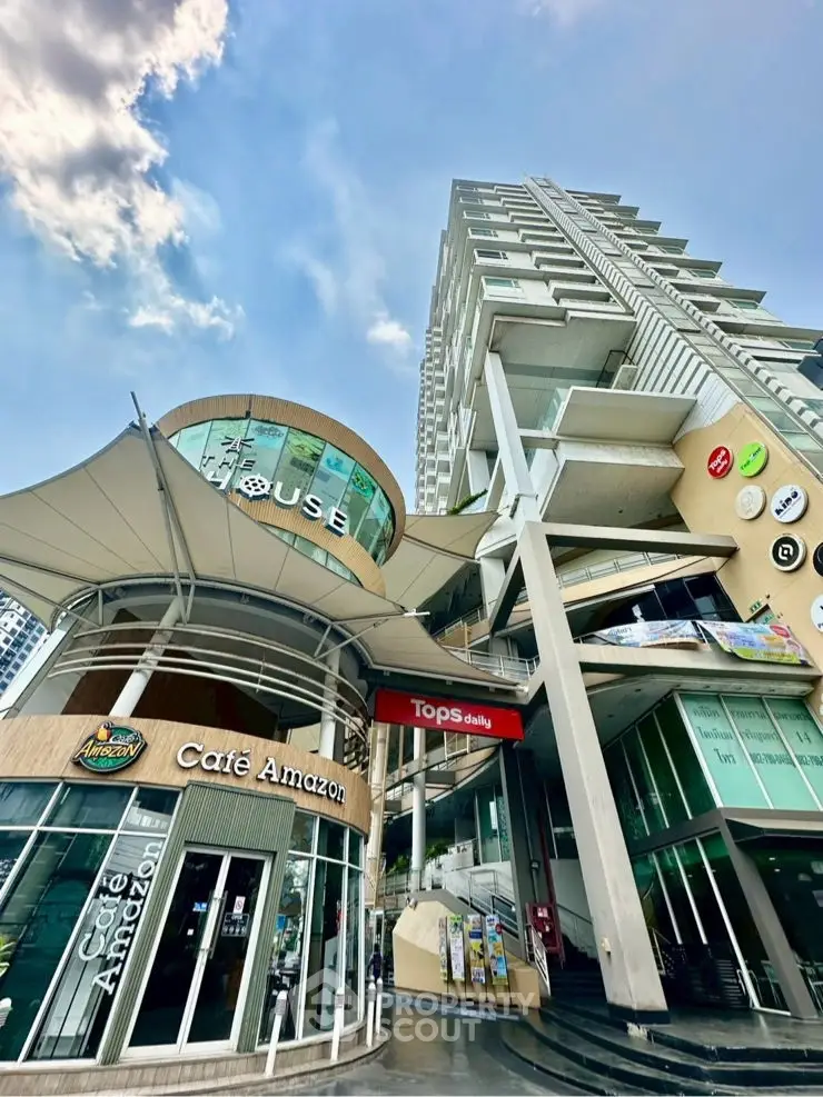 Modern commercial building with retail shops and unique architectural design