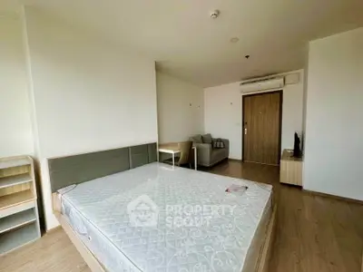 Spacious bedroom with modern furnishings and natural light, perfect for comfortable living.
