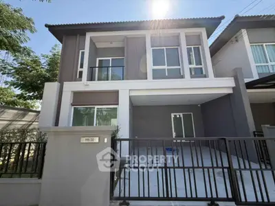 Modern two-story house with sleek design and spacious driveway in a serene neighborhood.