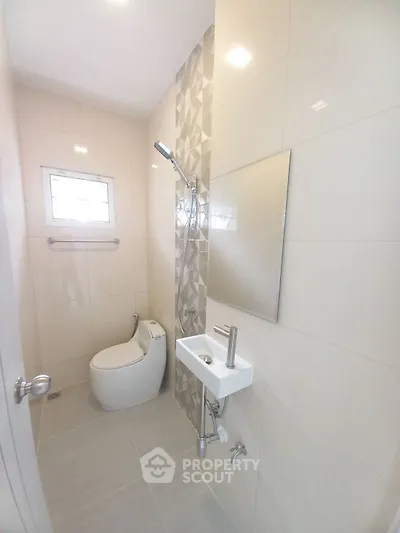 Modern minimalist bathroom with sleek fixtures and geometric tile design