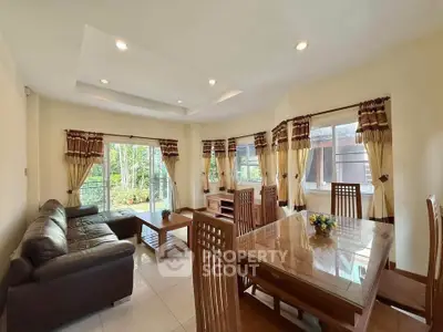 Spacious living room with elegant dining area and garden view, perfect for family gatherings.