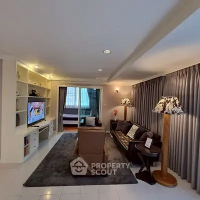 Spacious living room with modern decor and cozy seating area, perfect for relaxation and entertainment.