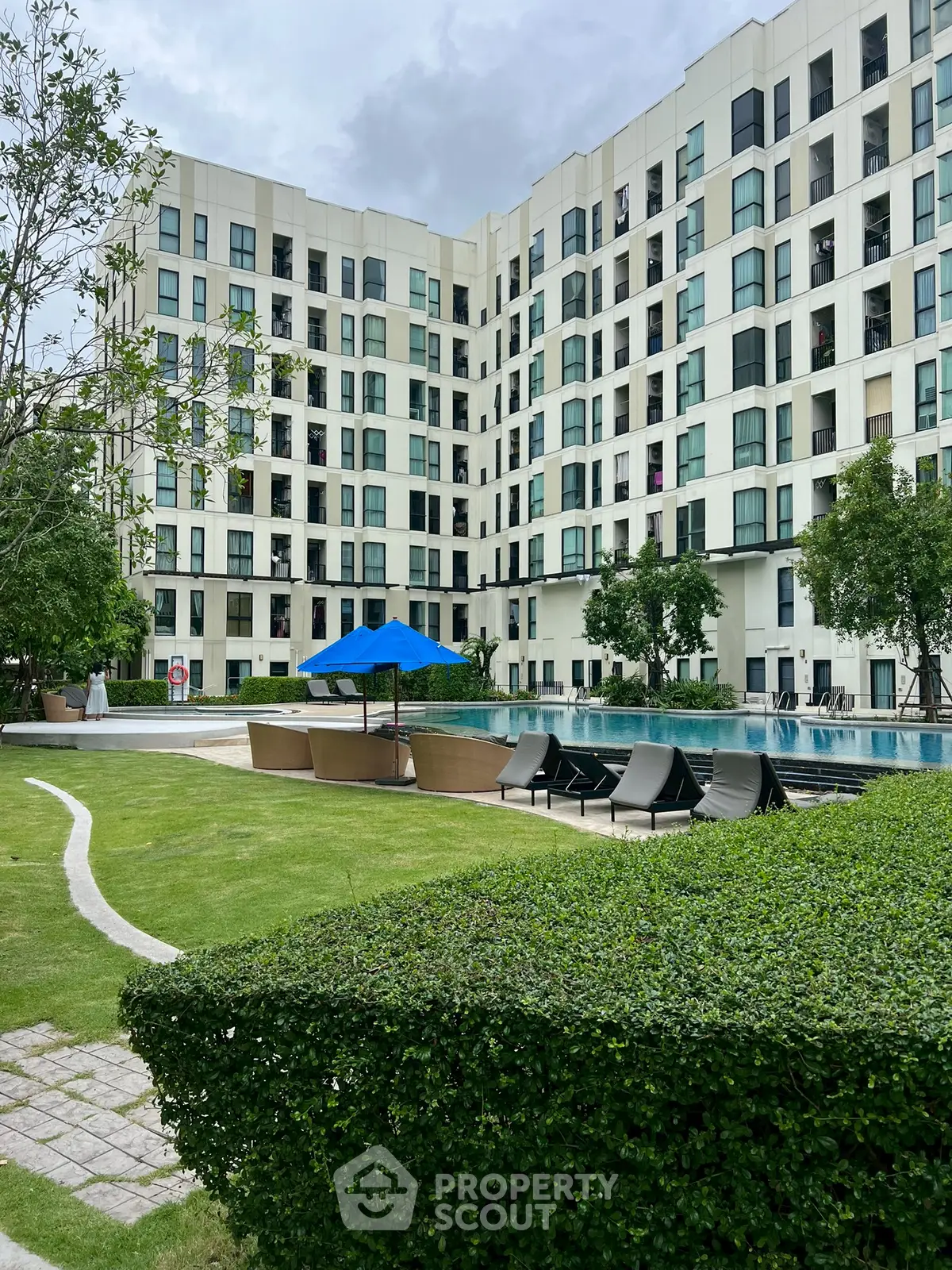 Modern apartment building with pool and garden view
