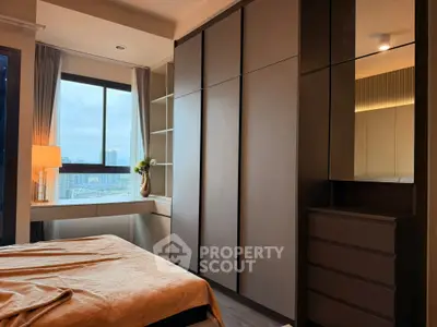 Modern bedroom with sleek built-in wardrobe and city view window, perfect for urban living.
