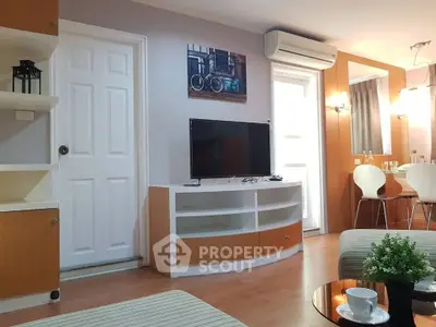 Modern living room with TV, air conditioning, and stylish decor