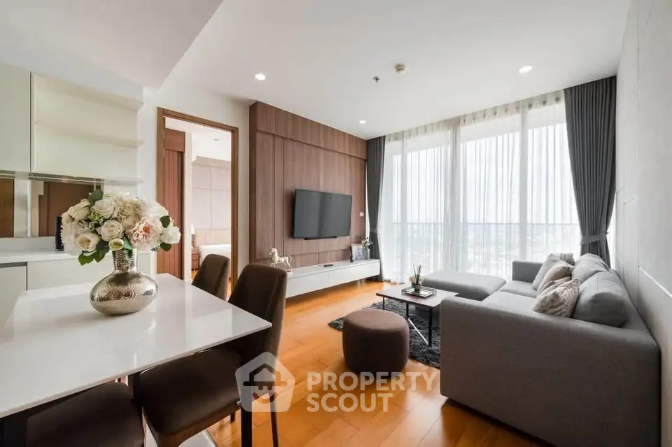 Modern living room with elegant decor and large windows offering a stunning view, perfect for relaxation.