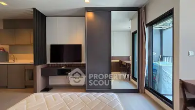 Modern bedroom with sleek design, large window, and integrated TV unit in a stylish apartment.