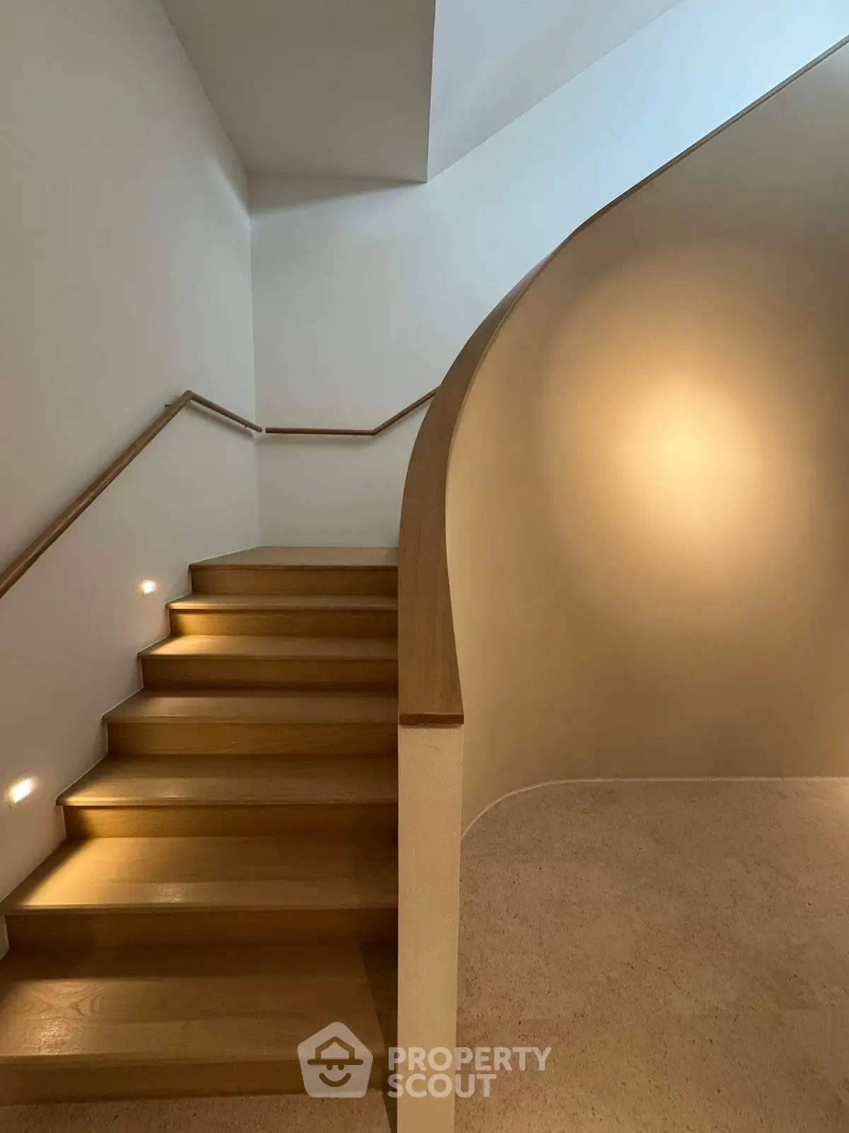 Elegant wooden staircase with modern lighting in a stylish home interior