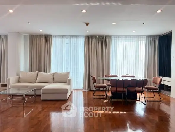 Spacious living room with elegant dining area and large windows