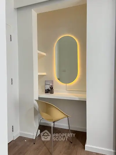 Modern study nook with illuminated mirror and sleek chair in stylish apartment.