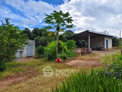 Charming rural property with lush greenery and spacious outdoor area.