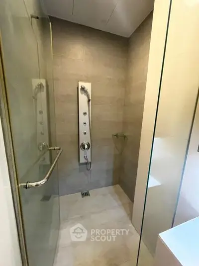 Modern shower area with sleek glass doors and rainfall showerhead