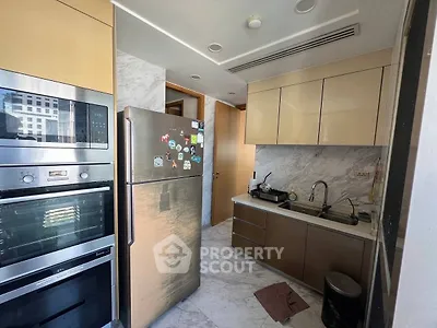 Modern kitchen with sleek cabinetry and stainless steel appliances in a stylish apartment.