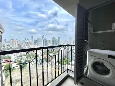 Stunning city view from high-rise balcony with washing machine