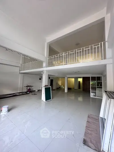 Spacious two-story open-plan interior with high ceilings and modern design, ideal for versatile living or commercial use.