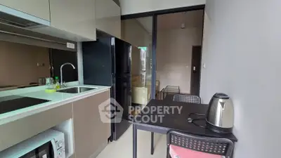 Modern kitchen with sleek appliances and dining area in stylish apartment