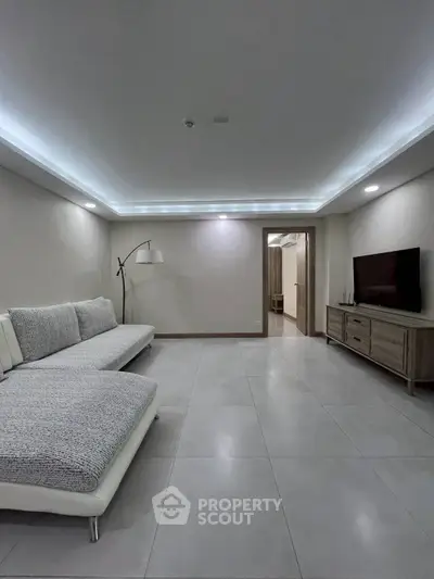 Spacious modern living room with sleek lighting and minimalist decor