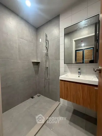 Modern bathroom with sleek design, featuring a spacious walk-in shower and stylish vanity.