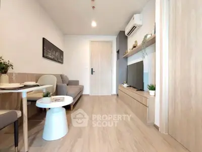 Modern living room with sleek design, featuring a cozy sofa, wall-mounted TV, and stylish decor.