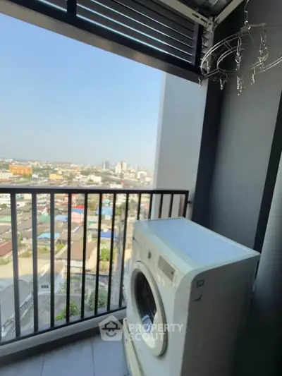 High-rise balcony with washing machine and panoramic city view, perfect for urban living.