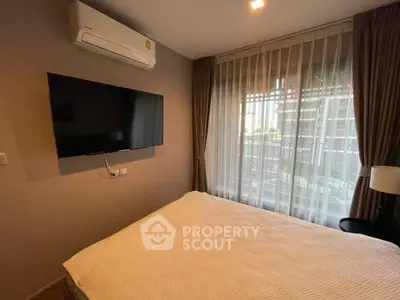 Cozy bedroom with modern air conditioning and large window view