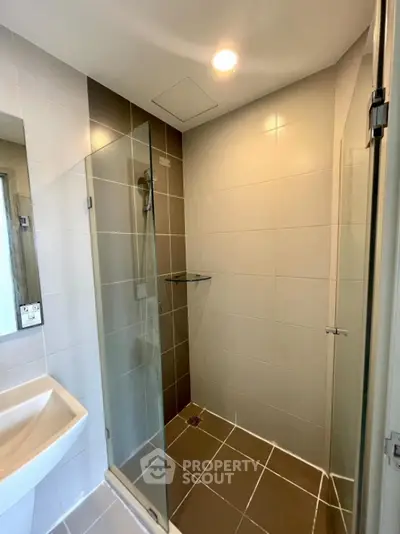 Modern bathroom with glass shower enclosure and sleek tile design