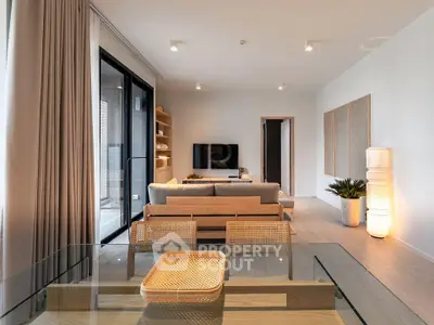 Modern living room with stylish decor and large windows in a contemporary apartment.