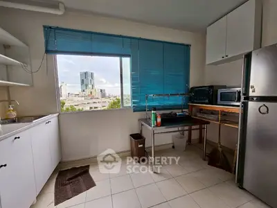 Bright kitchen with city view, featuring modern appliances and ample storage space.