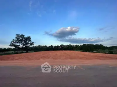Expansive land plot with clear skies, ideal for development opportunities.