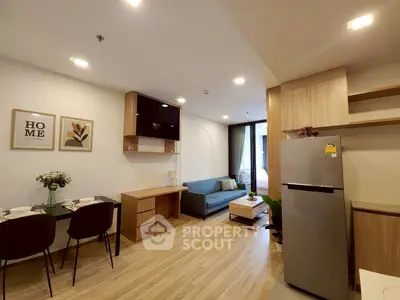 Modern open-layout living room with stylish decor and kitchen area