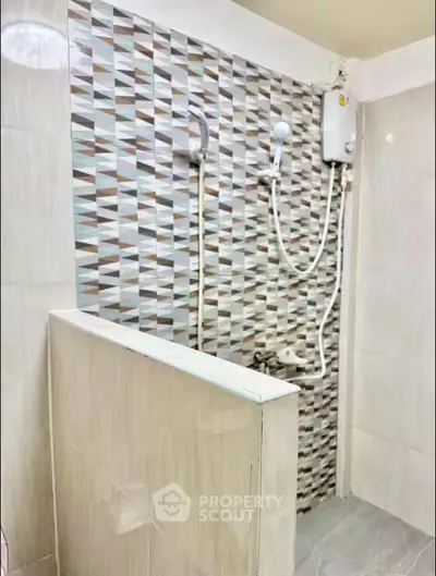 Modern bathroom with stylish geometric tiles and electric water heater