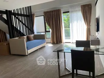 Spacious modern living room with large windows and elegant decor