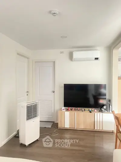 Modern living room with sleek TV setup and air conditioning