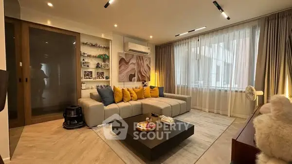 Modern living room with stylish decor and large windows for natural light.