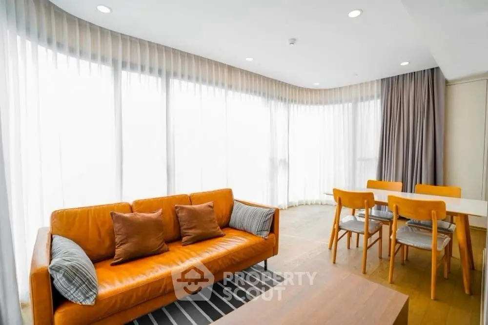 Spacious modern living room with large windows and stylish furniture