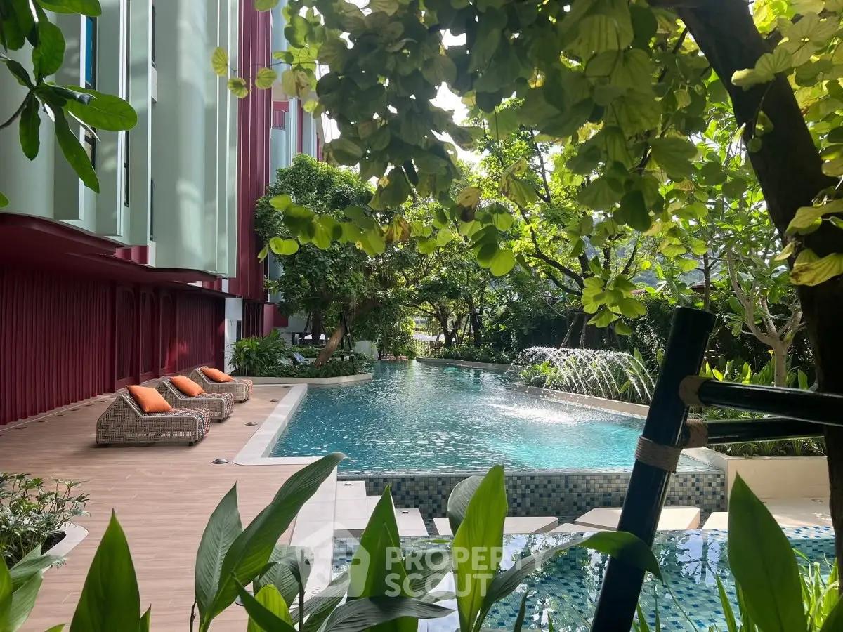 Luxurious poolside area with lush greenery and modern design, perfect for relaxation and leisure.
