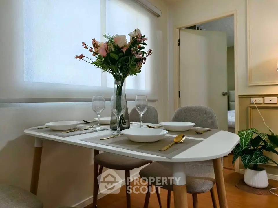 Charming dining area with elegant table setting and natural light, perfect for intimate gatherings.