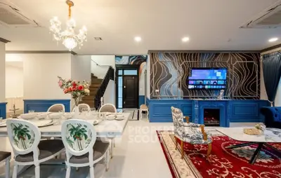 Luxurious living room with elegant dining area, chandelier, and modern decor