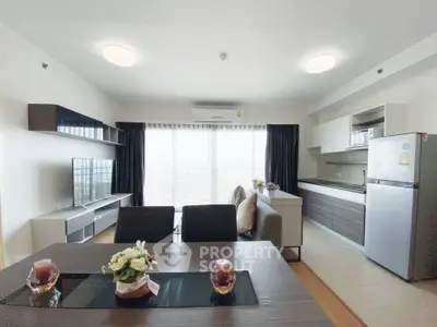 Modern open-plan living room with stylish kitchen and large windows