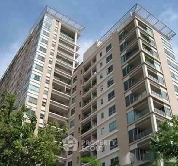 Modern high-rise apartment building with spacious balconies and sleek design.
