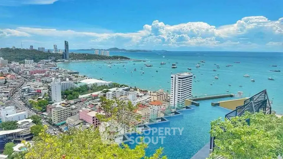 Stunning ocean view from high-rise building with infinity pool overlooking cityscape and harbor.