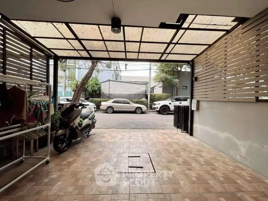 Spacious covered parking area with tiled flooring and modern design.