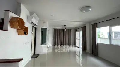 Spacious modern living room with large windows and air conditioning